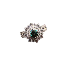 Silver brooch with a central green gemstone on a white background