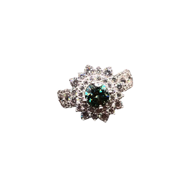 Silver brooch with a central green gemstone on a white background