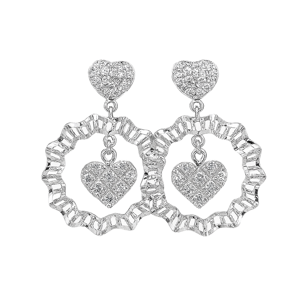 Silver heart-shaped earrings with clear gemstones on a white background