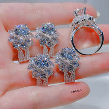 Silver jewelry set with rings and earrings on a hand