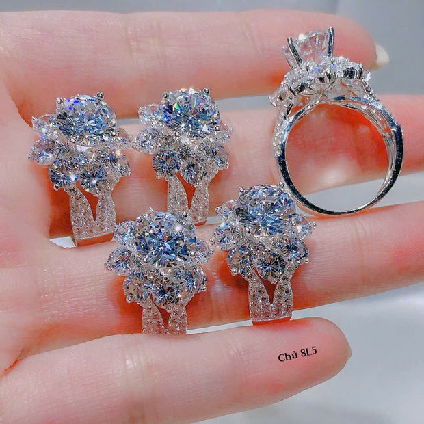 Silver jewelry set with rings and earrings on a hand