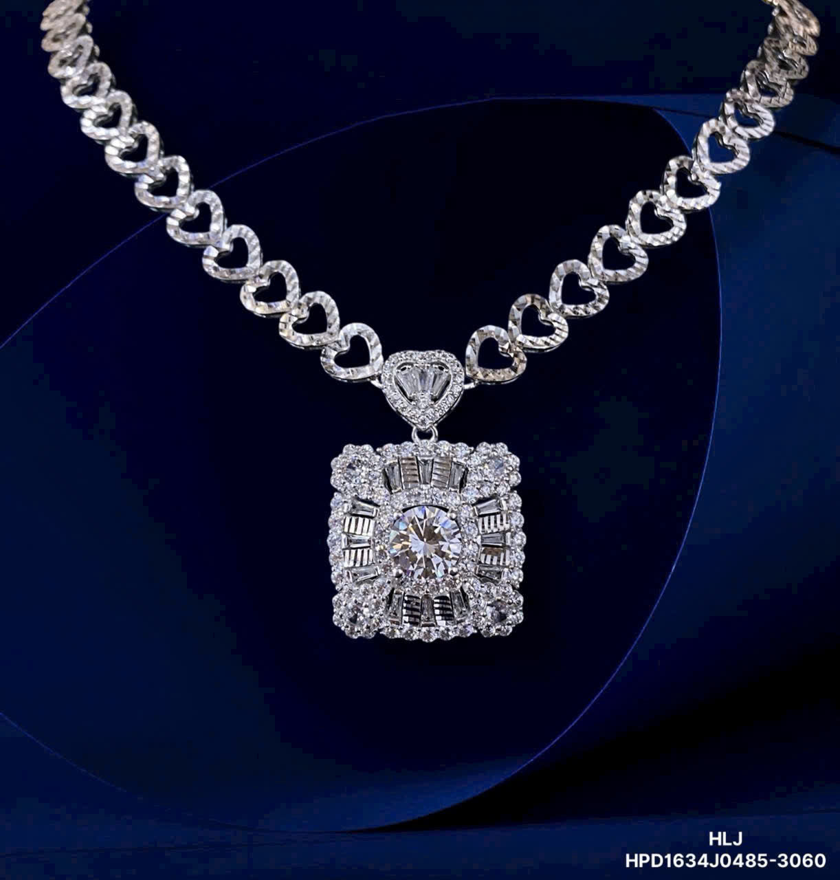 Silver necklace with a diamond pendant on a dark background