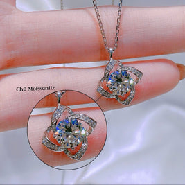 Silver necklace with a pendant on a hand, close-up view.