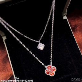 Silver necklace with a red flower pendant on a black background