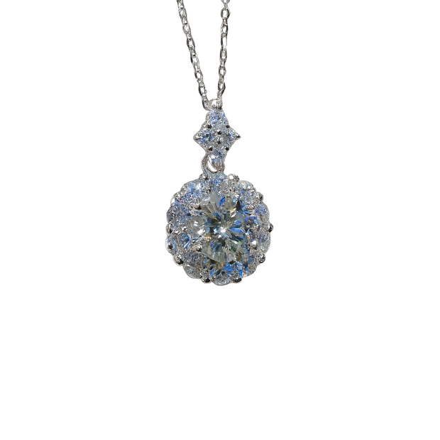 Silver necklace with a round, faceted pendant on a white background