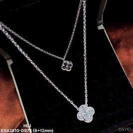 Silver necklace with clover-shaped pendants on a black background