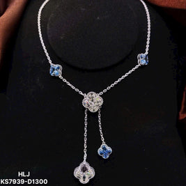 Silver necklace with floral designs on a black background