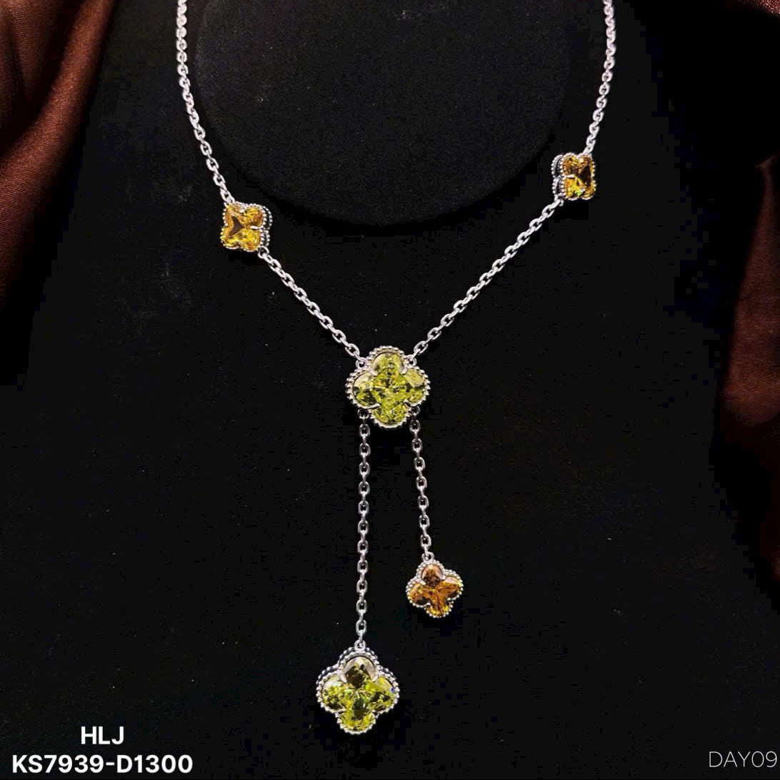 Silver necklace with floral pendant on a black background