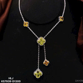 Silver necklace with floral pendant on a black background