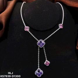 Silver necklace with purple and pink floral pendants on a black stand