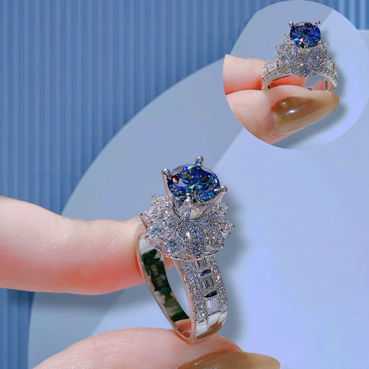 Silver ring with blue gemstone held by a hand against a light blue background