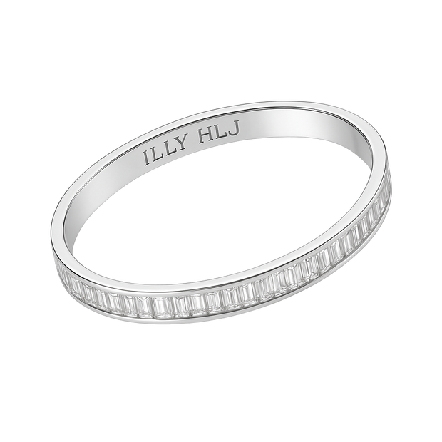 Silver ring with baguette cut stones on a white background