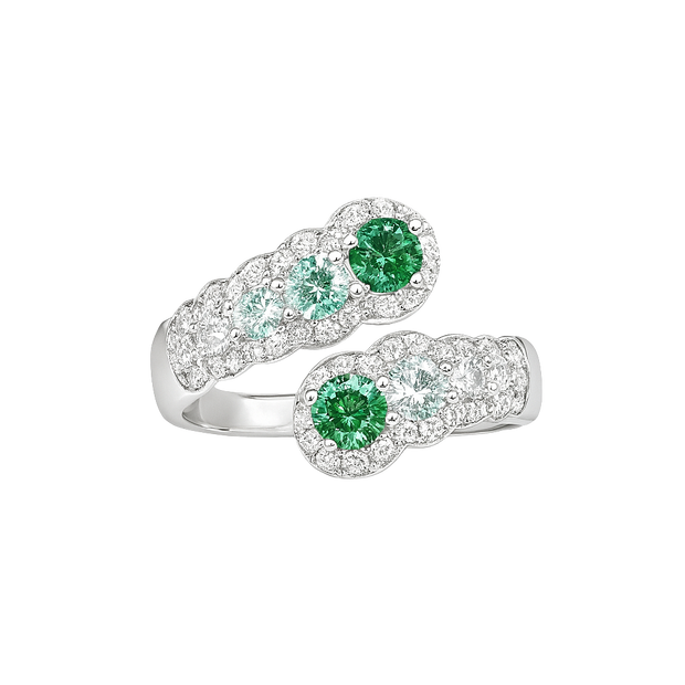 Silver ring with green gemstones on a white background