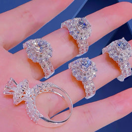 Silver rings with gemstones on a hand against a blue background