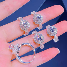 Silver turtle-shaped jewelry set on a hand with a blue background