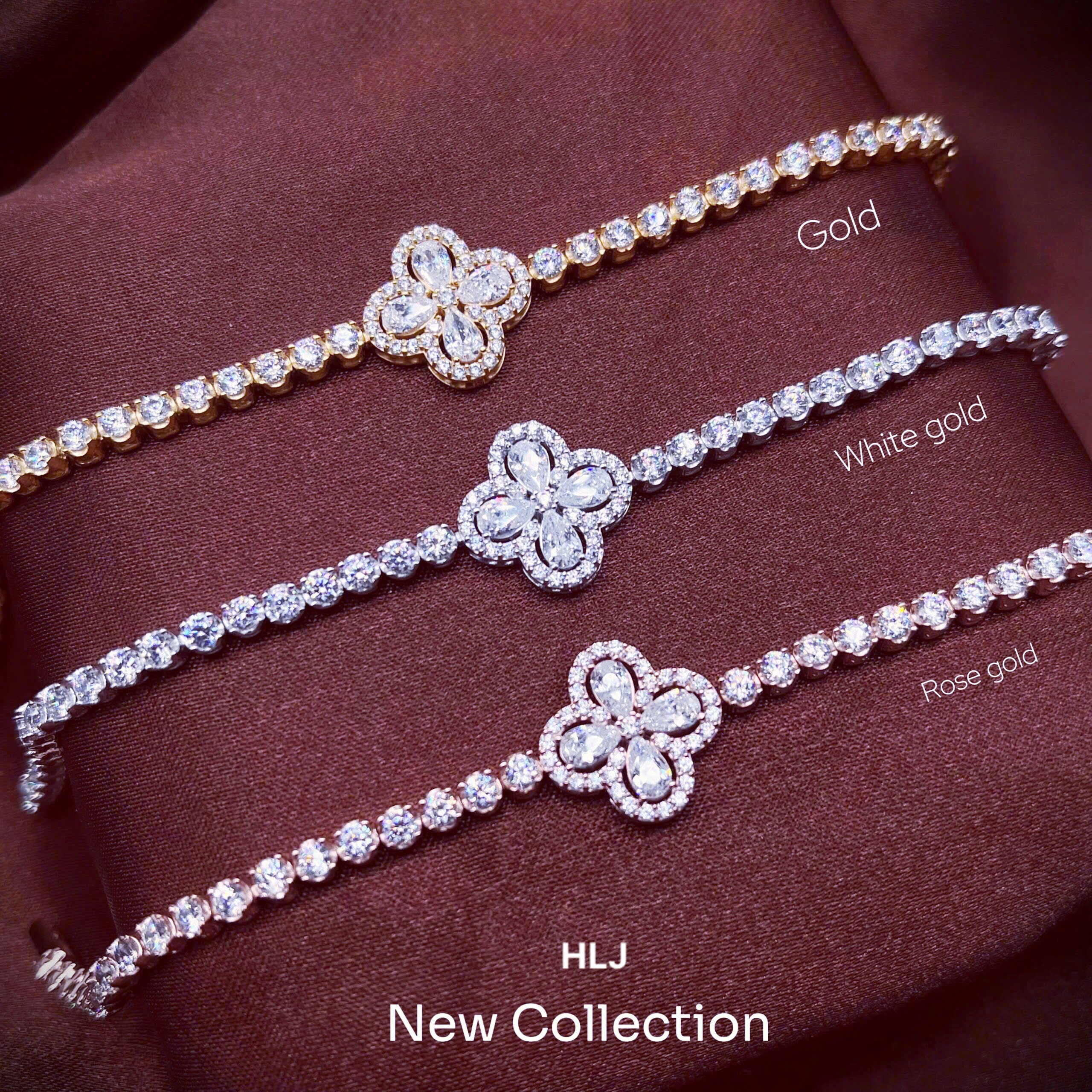 Three diamond bracelets in gold, white gold, and rose gold on a brown fabric background.