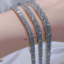 Three diamond bracelets on a person's wrist with a blurred background