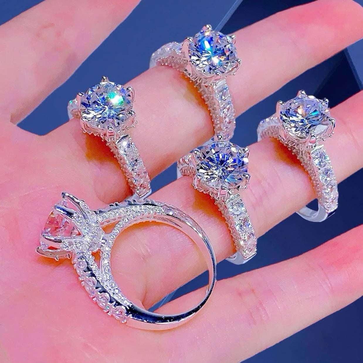 Three diamond rings on a hand with a dark background