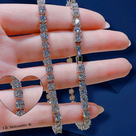 Two diamond bracelets on a hand with a blue background