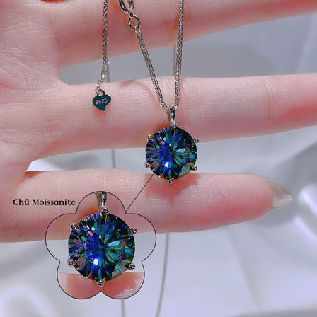 Two gemstone necklaces on a hand with a blurred background