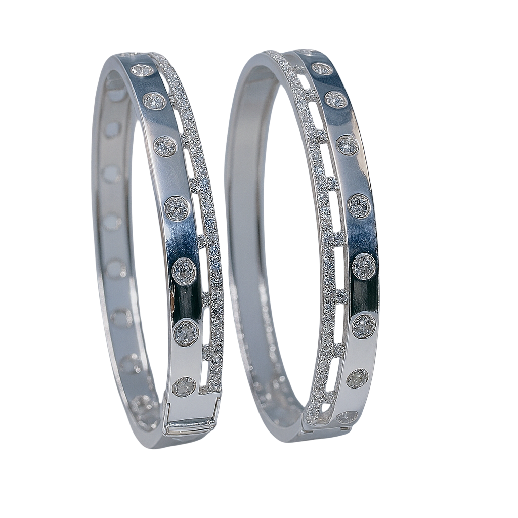 Two silver bangles with embedded stones on a white background