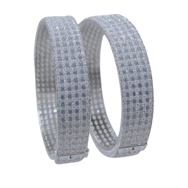 Two silver bracelets with blue gemstones on a white background