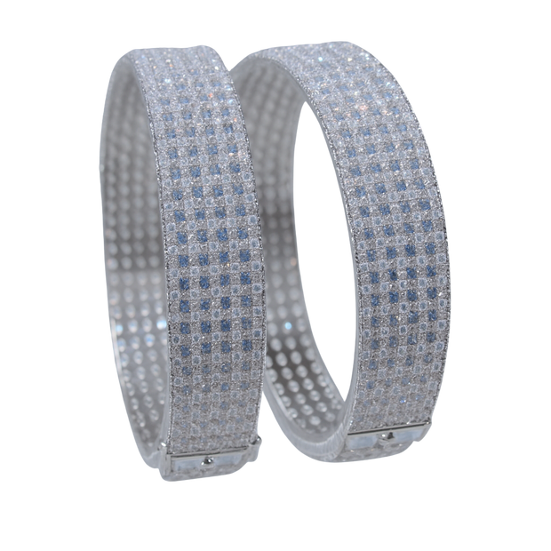 Two silver bracelets with blue gemstones on a white background