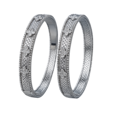 Two silver rings with floral and diamond designs on a white background