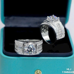 Two silver rings with gemstones in a teal box.