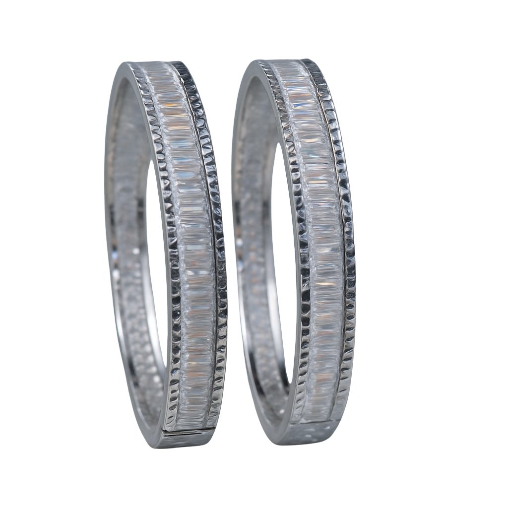 Two silver wedding bands with diamond accents on a white background