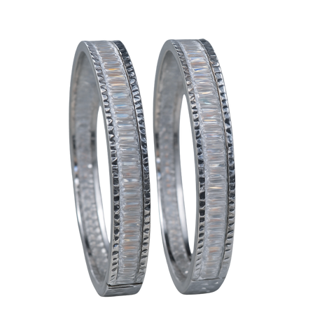 Two silver wedding bands with diamond accents on a white background