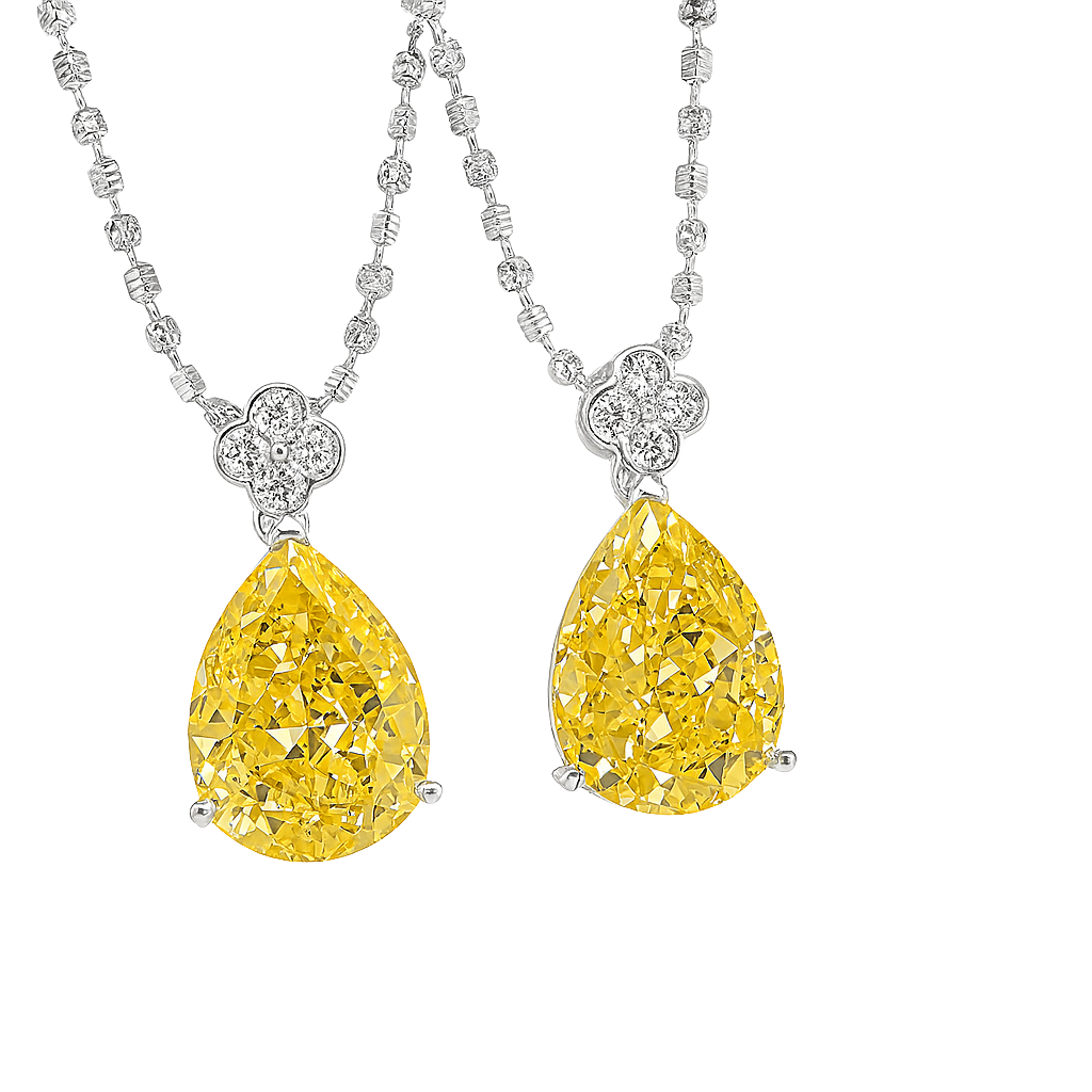 Two yellow diamond pendants on a silver chain against a white background
